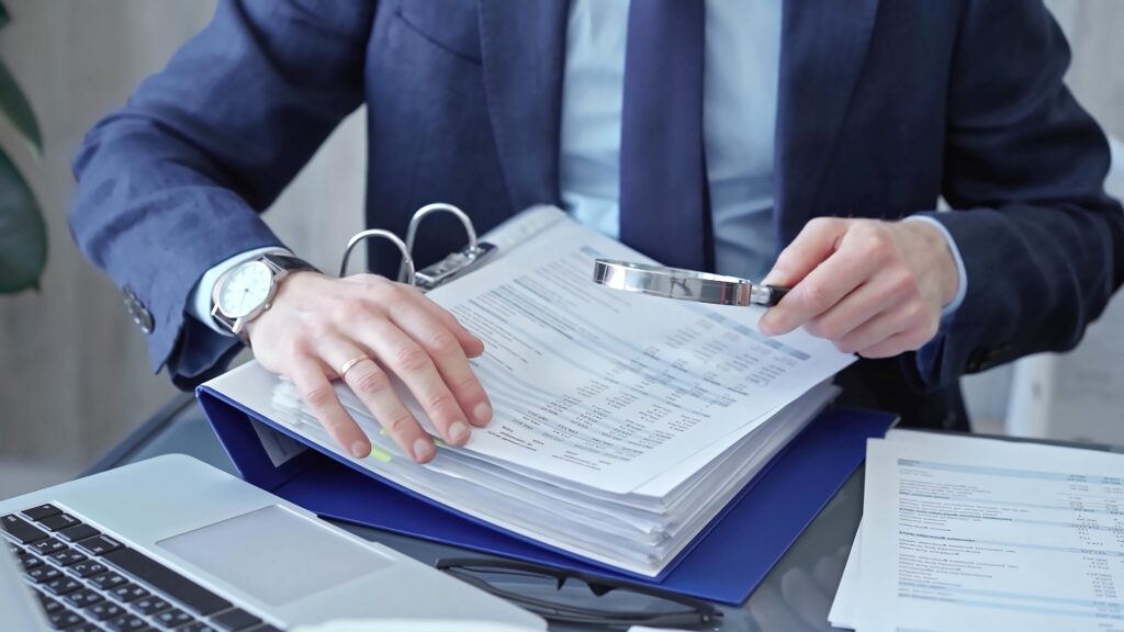 Buyer carefully reviewing business financials to validate them