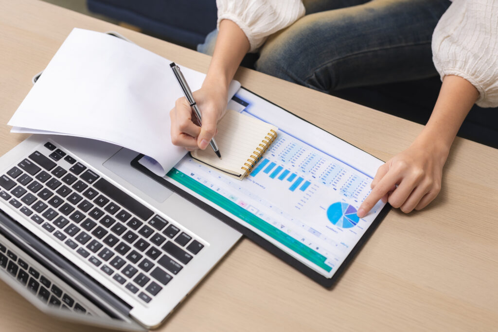 Business owner reviewing post-sale performance numbers